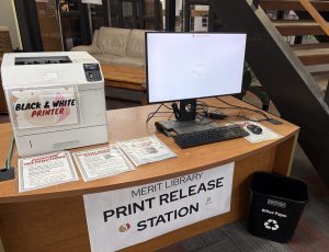 computer and printer release station on desk by stairway