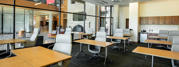 Photo of room 198 in the Education Building. Rows of desks and chairs