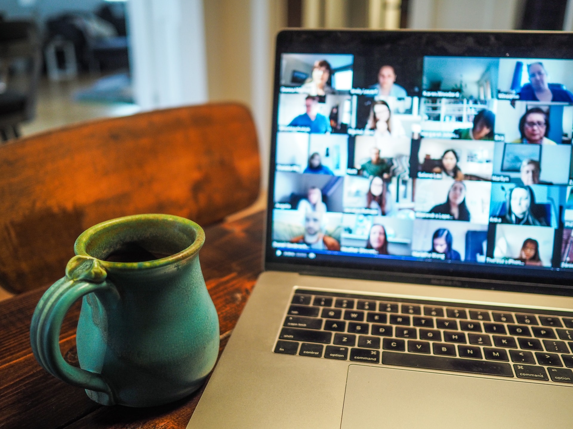 table with mug and laptop with zoom event