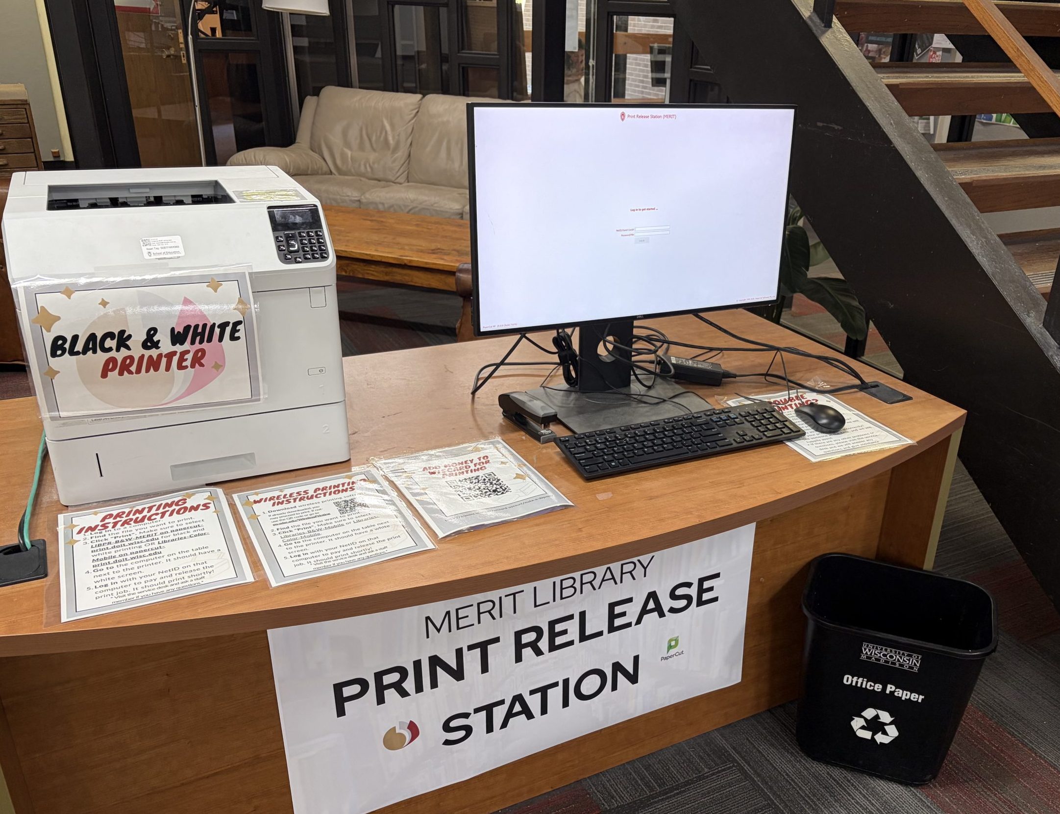 computer and printer release station on desk by stairway
