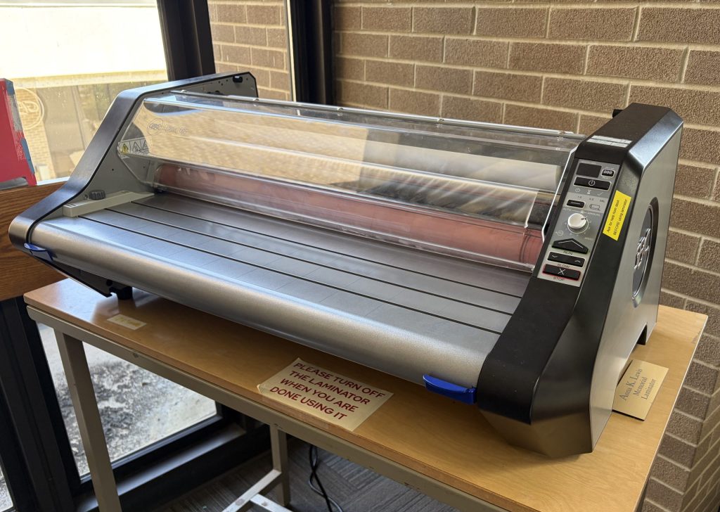 Hot-roll laminator on o table in library sapce