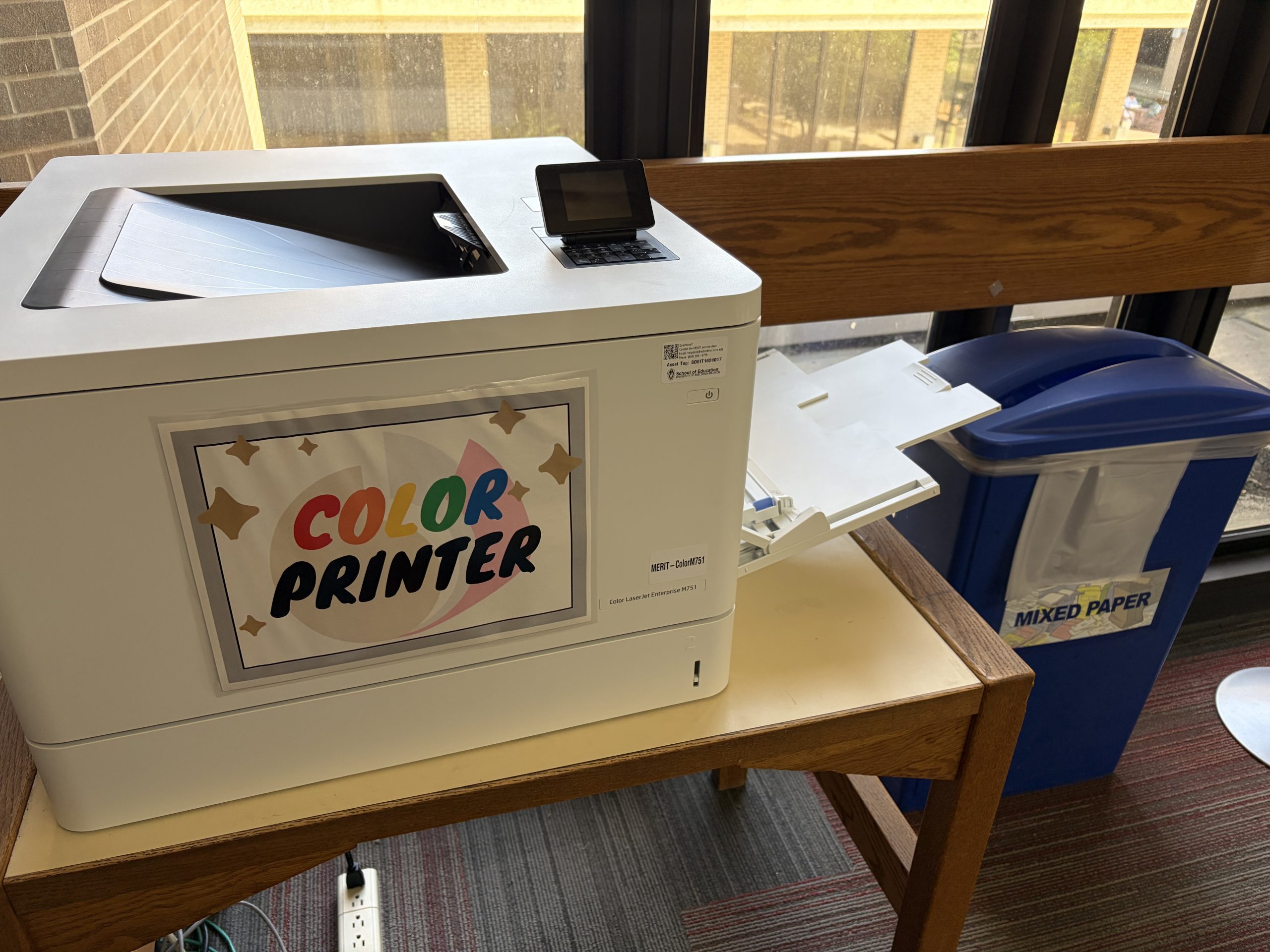 Color printer on a table with paper tray extended